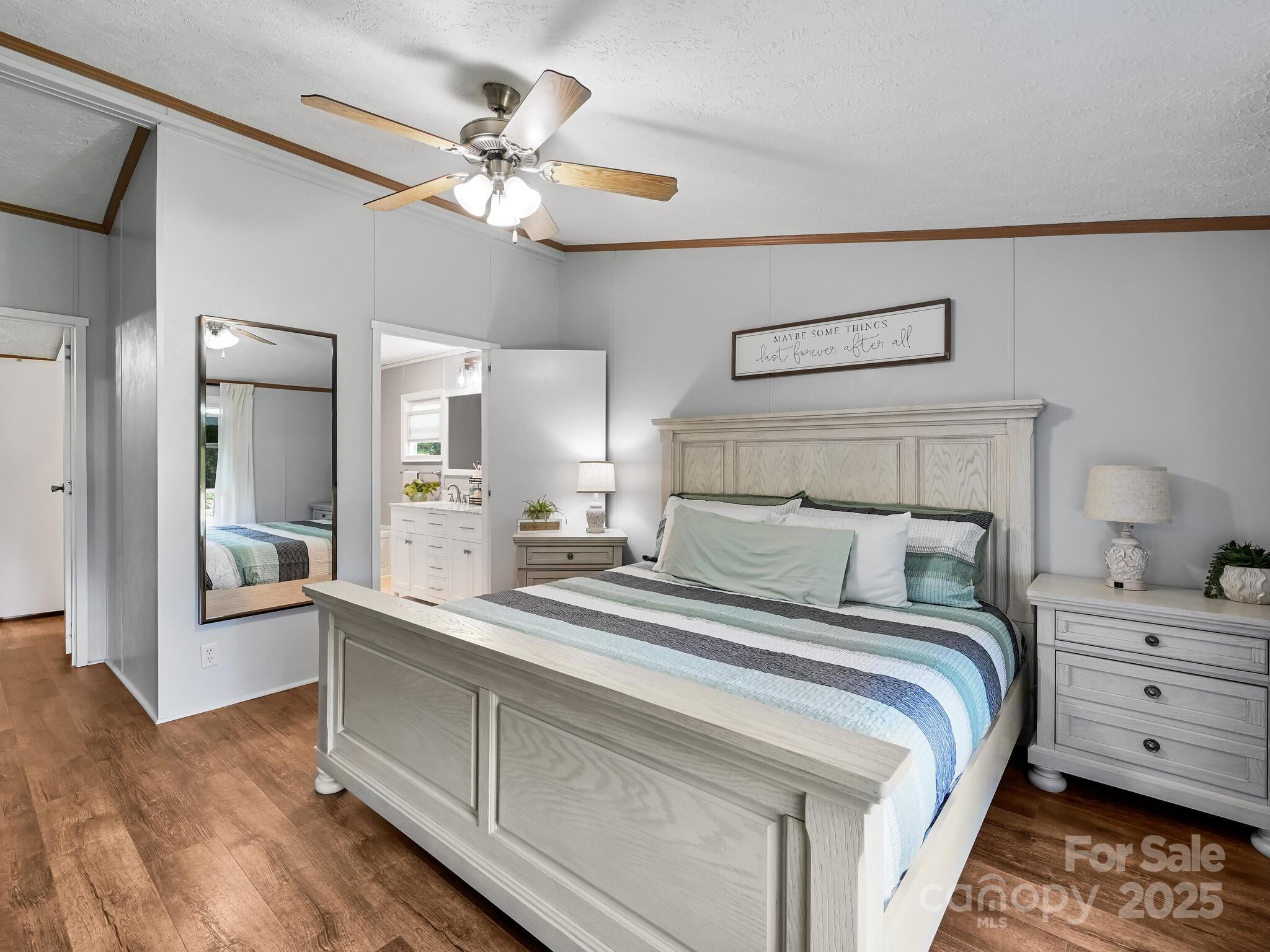 450 Berry Wills Road Hot Springs, NC 28743 - Photo 23 of 48 a bedroom with a bed and a chandelier