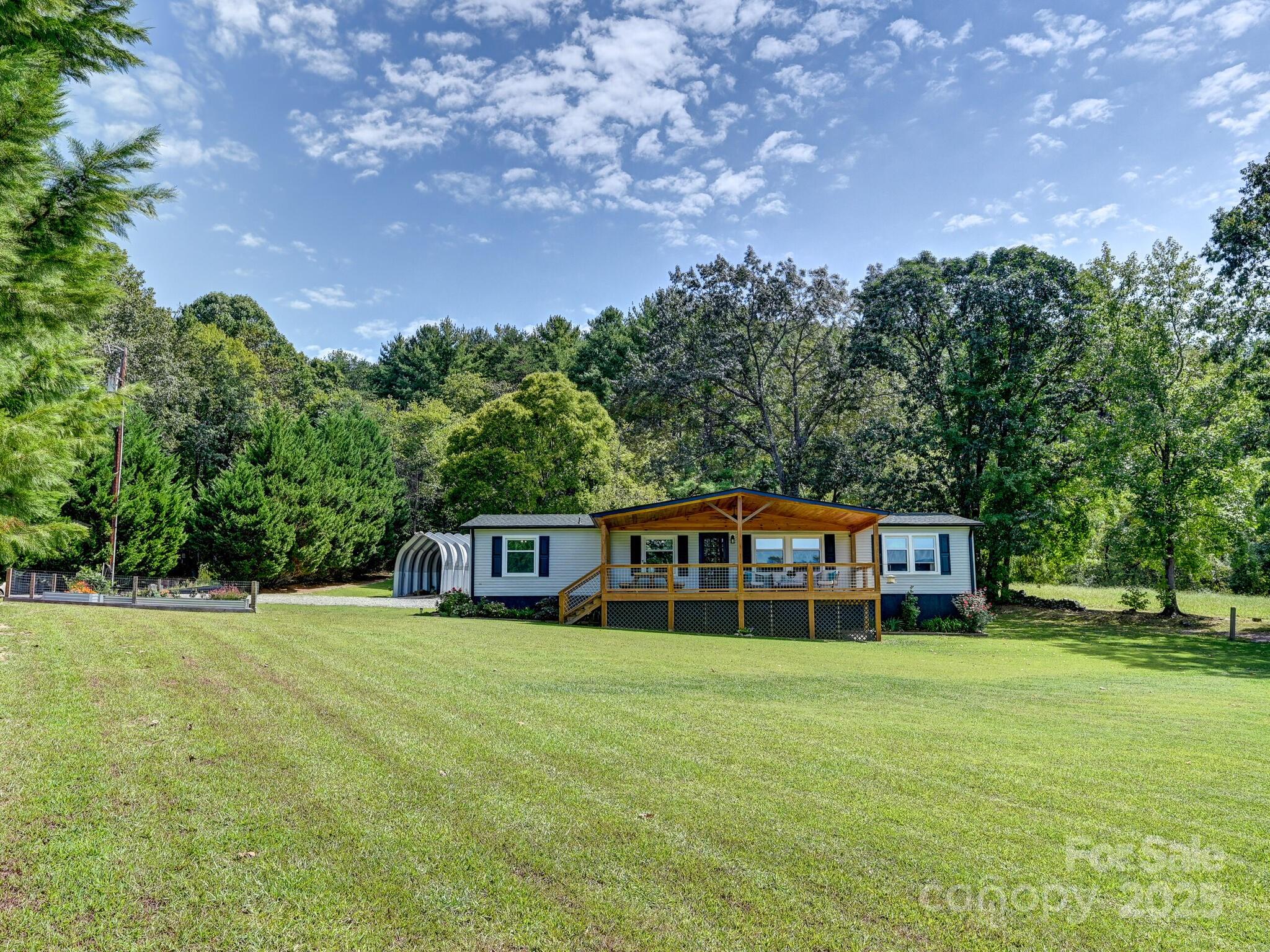 450 Berry Wills Road Hot Springs, NC 28743 - Photo 33 of 48 a view of a house with a big yard and large trees