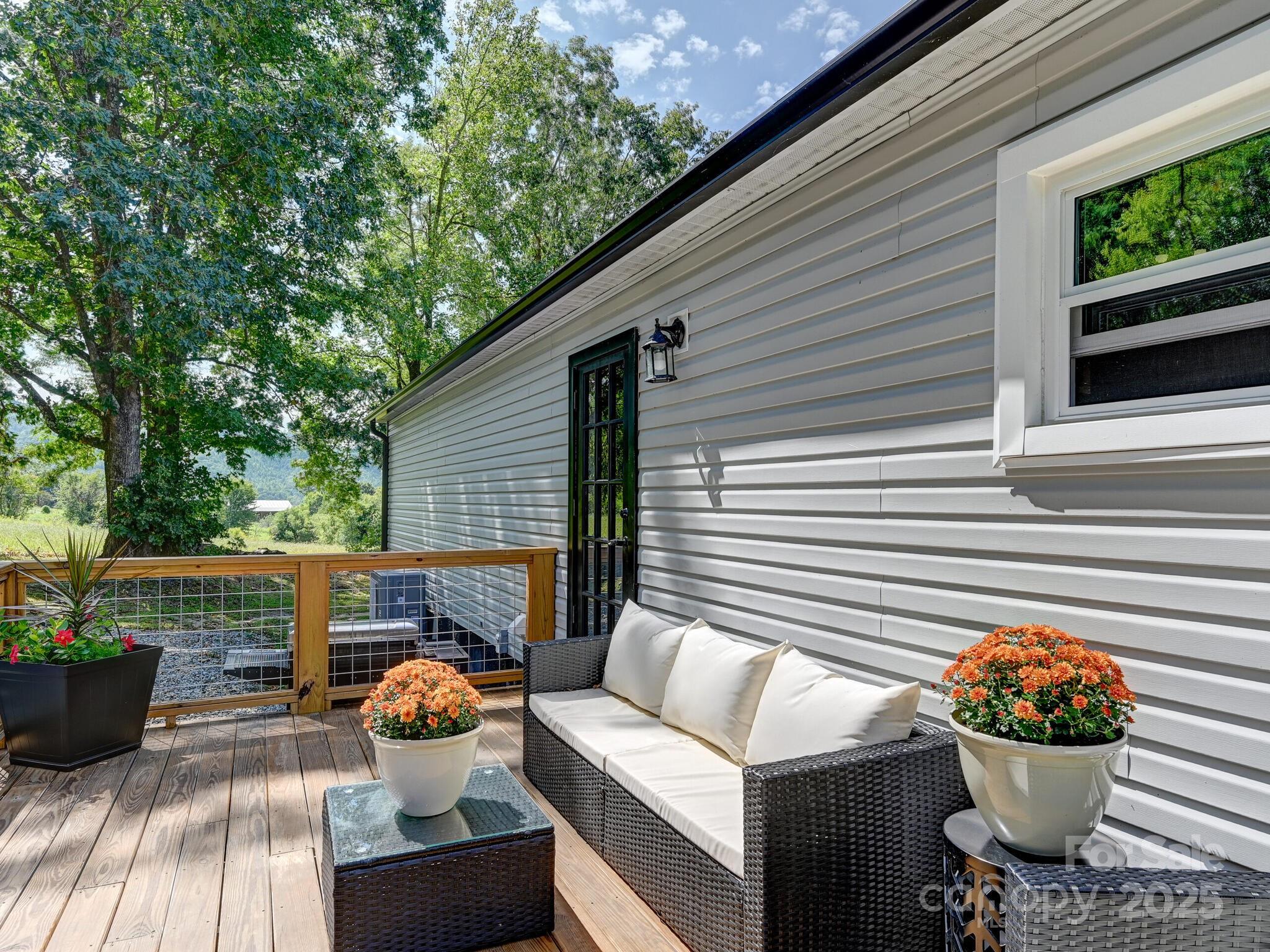 450 Berry Wills Road Hot Springs, NC 28743 - Photo 42 of 48 a view of a porch with furniture and wooden fence