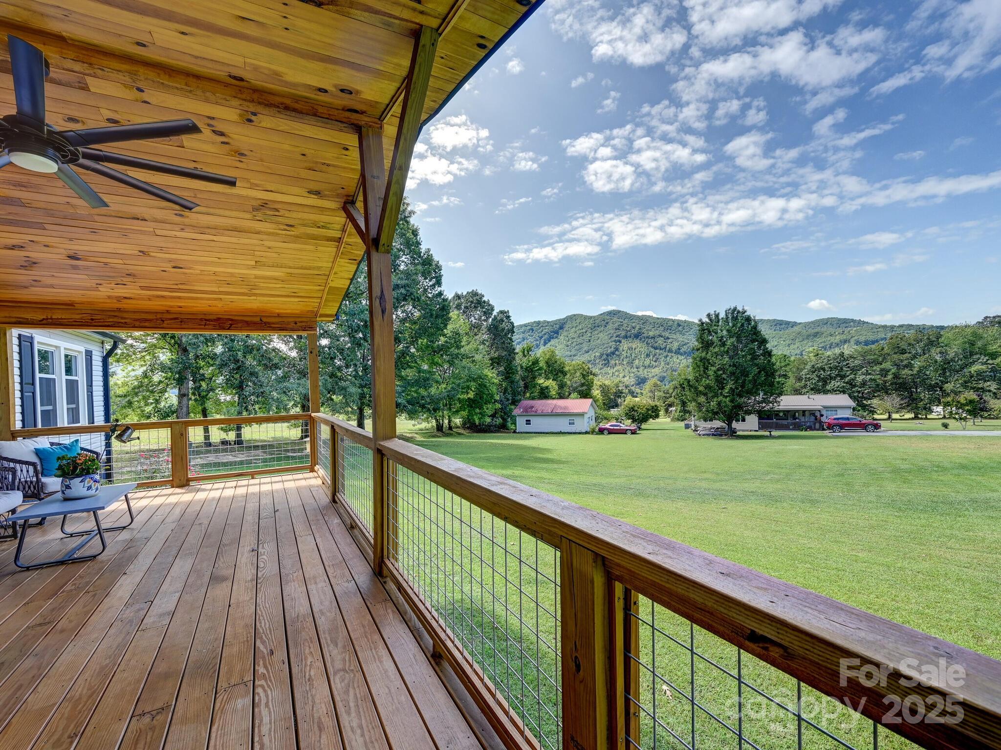 450 Berry Wills Road Hot Springs, NC 28743 - Photo 7 of 48 a view of balcony with wooden floor and fence