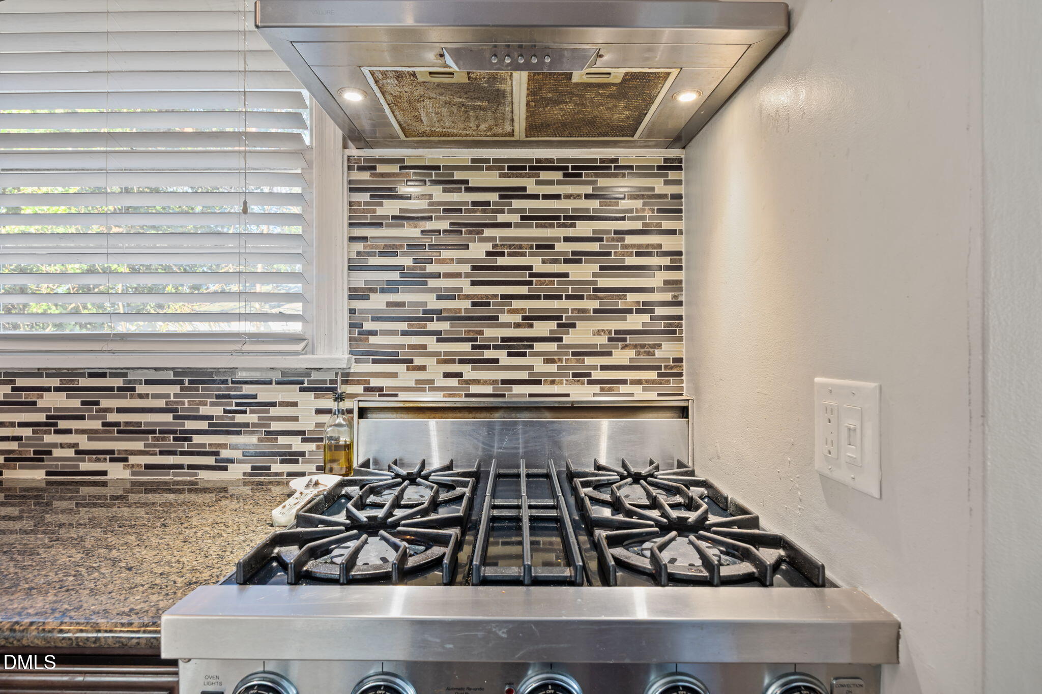 728 East Whitaker Mill Road Raleigh, NC 27608 - Photo 12 of 39 a close view of a stove a microwave oven and next to a window
