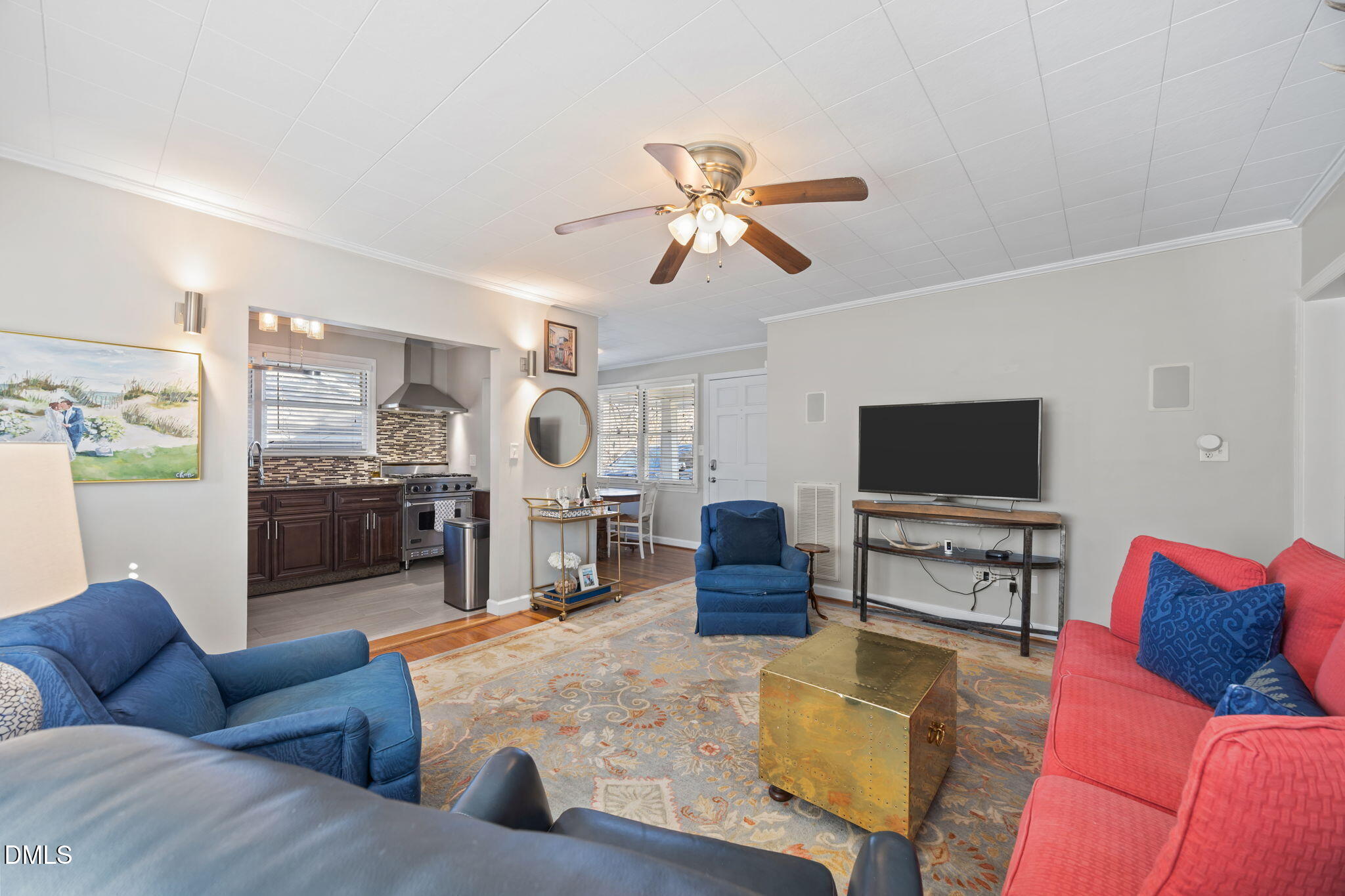 728 East Whitaker Mill Road Raleigh, NC 27608 - Photo 13 of 39 a living room with furniture and a flat screen tv