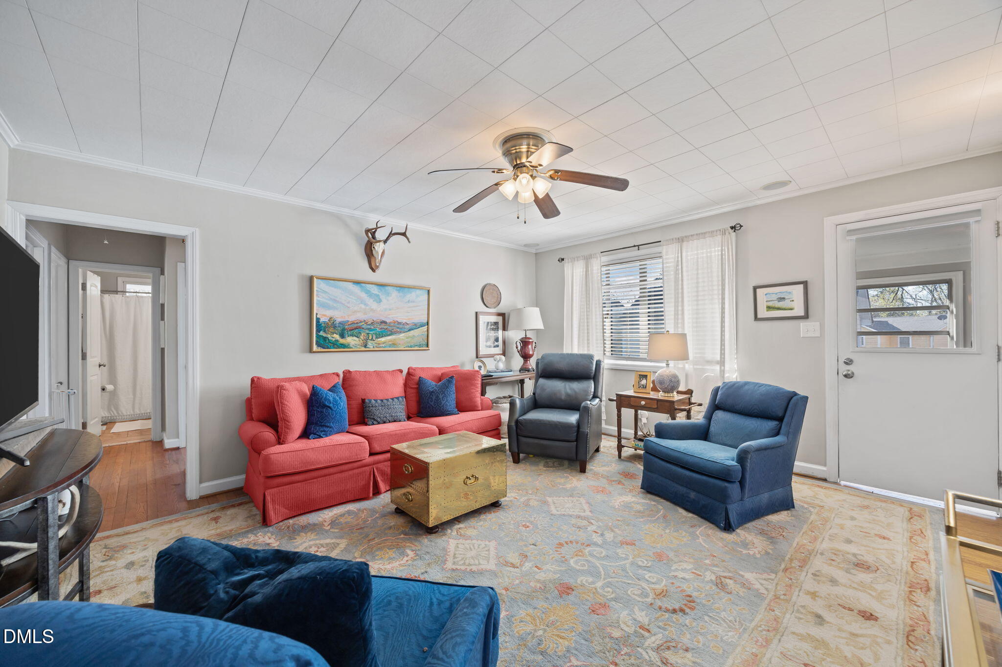 728 East Whitaker Mill Road Raleigh, NC 27608 - Photo 16 of 39 a living room with furniture and a flat screen tv