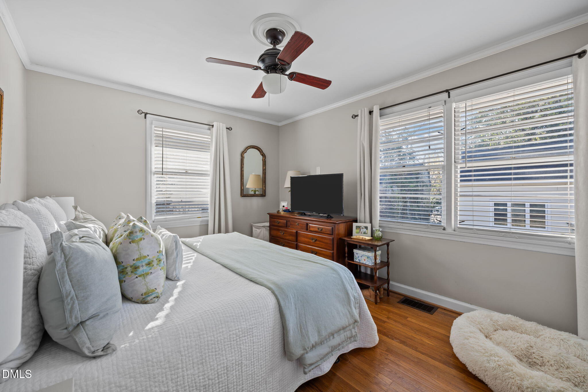 728 East Whitaker Mill Road Raleigh, NC 27608 - Photo 22 of 39 a bedroom with a bed and a flat screen tv