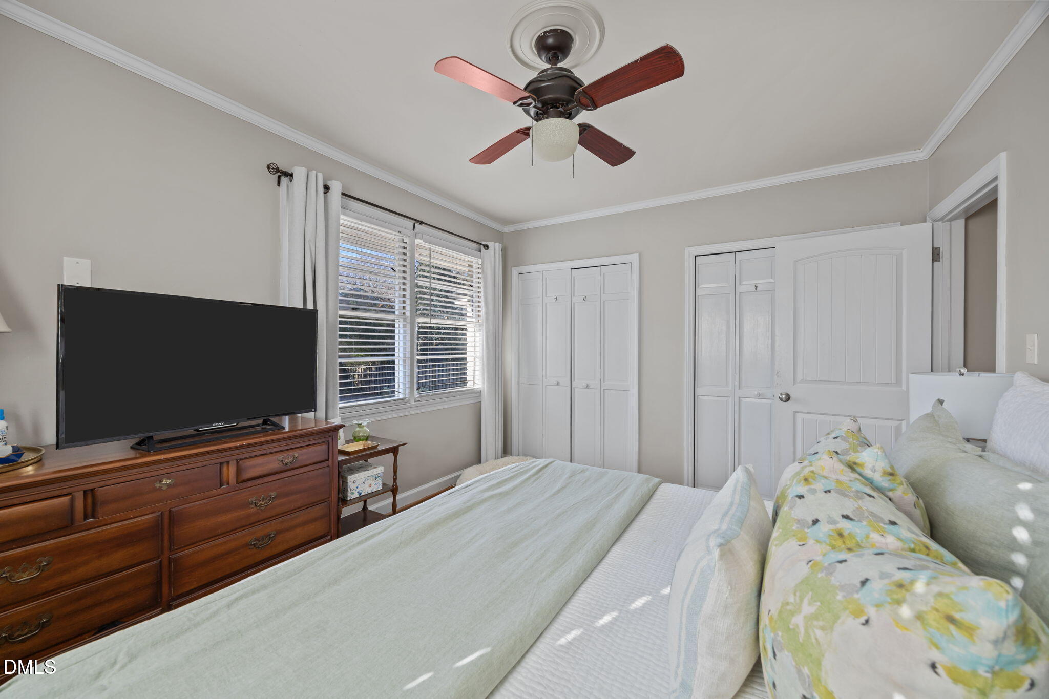 728 East Whitaker Mill Road Raleigh, NC 27608 - Photo 23 of 39 a bedroom with a bed and flat screen tv