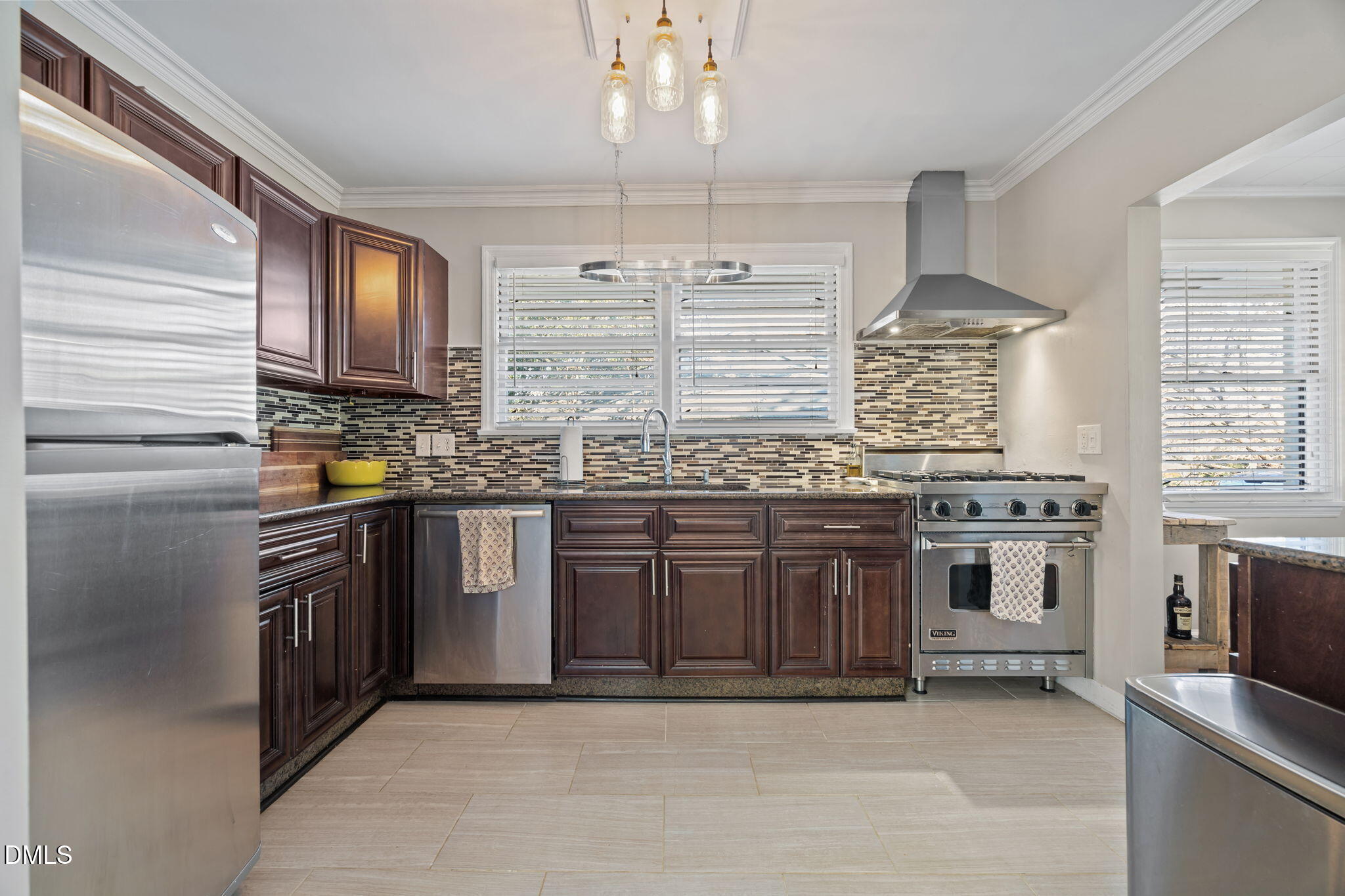 728 East Whitaker Mill Road Raleigh, NC 27608 - Photo 9 of 39 a kitchen with stainless steel appliances granite countertop a stove sink and cabinets