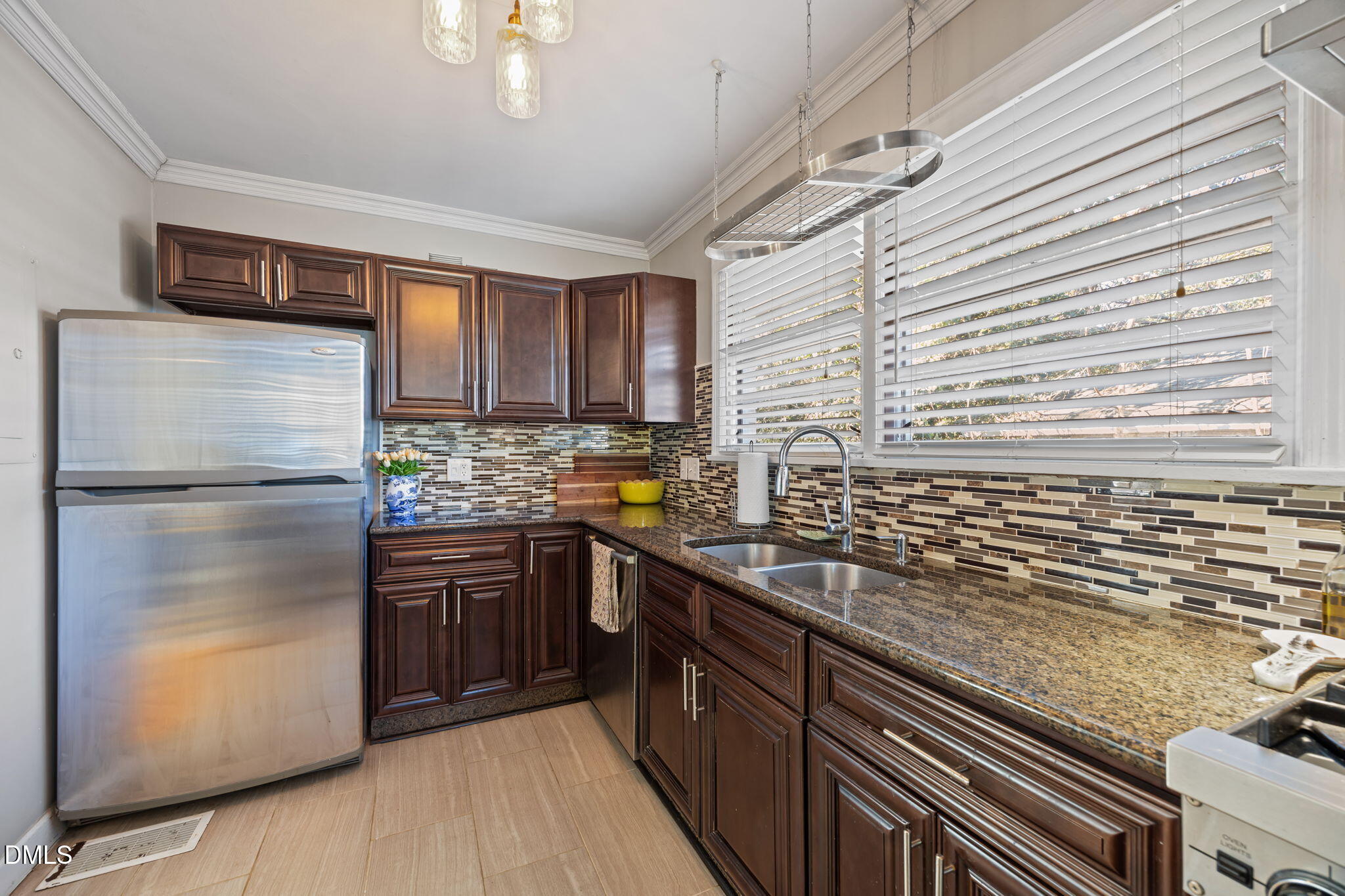 728 East Whitaker Mill Road Raleigh, NC 27608 - Photo 10 of 39 a kitchen with stainless steel appliances granite countertop a refrigerator a sink dishwasher a stove with wooden cabinets