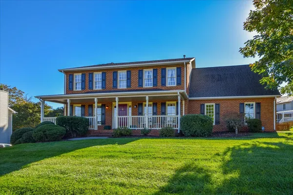 a front view of a house with garden and porch