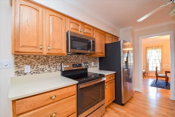 a kitchen with granite countertop a stove top oven microwave and cabinets