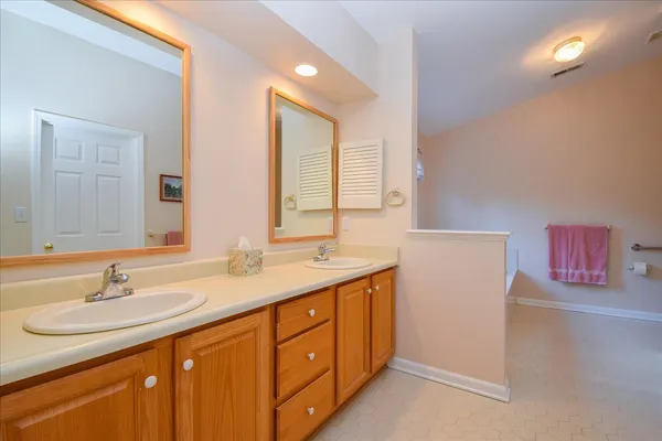 a white bath tub sitting in a bathroom next to a window
