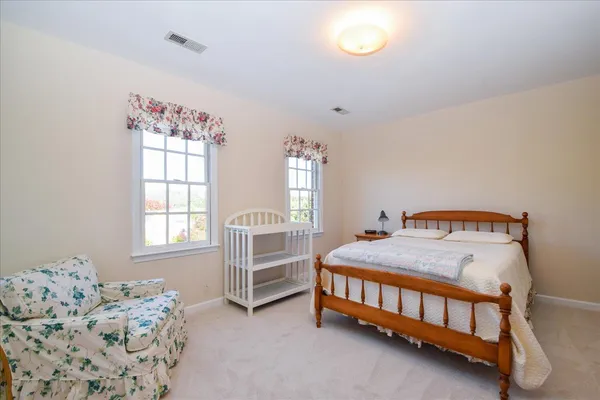 a bedroom with a bed and a book shelf