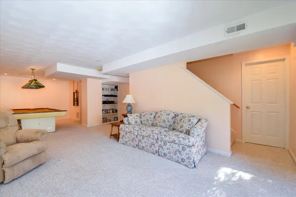 a room with pool table and a chandelier
