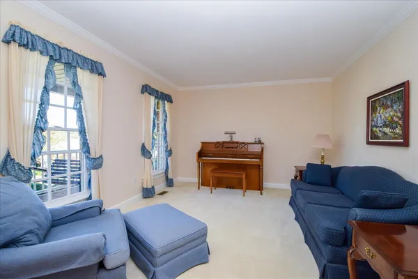 a living room with furniture a dining table and kitchen view
