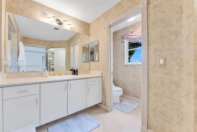a spacious bathroom with a double vanity sink and a mirror