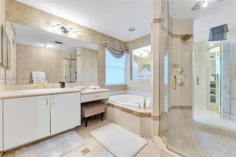 a spacious bathroom with a double vanity sink mirror and shower