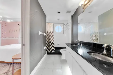 a spacious bathroom with a double vanity sink and a mirror