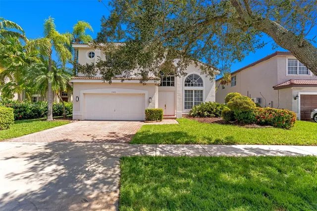 a front view of house with yard and green space