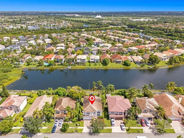 an aerial view of residential houses with outdoor space