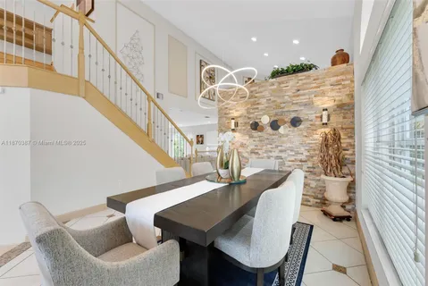 a view of a dining room with furniture and a chandelier