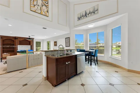 a kitchen with cabinets and chairs
