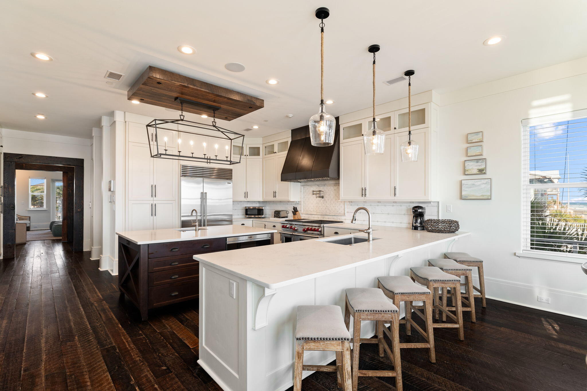 138 West Beach Drive Miramar Beach, FL 32550 - Photo 14 of 72 a kitchen with stainless steel appliances a table chairs stove and wooden floor