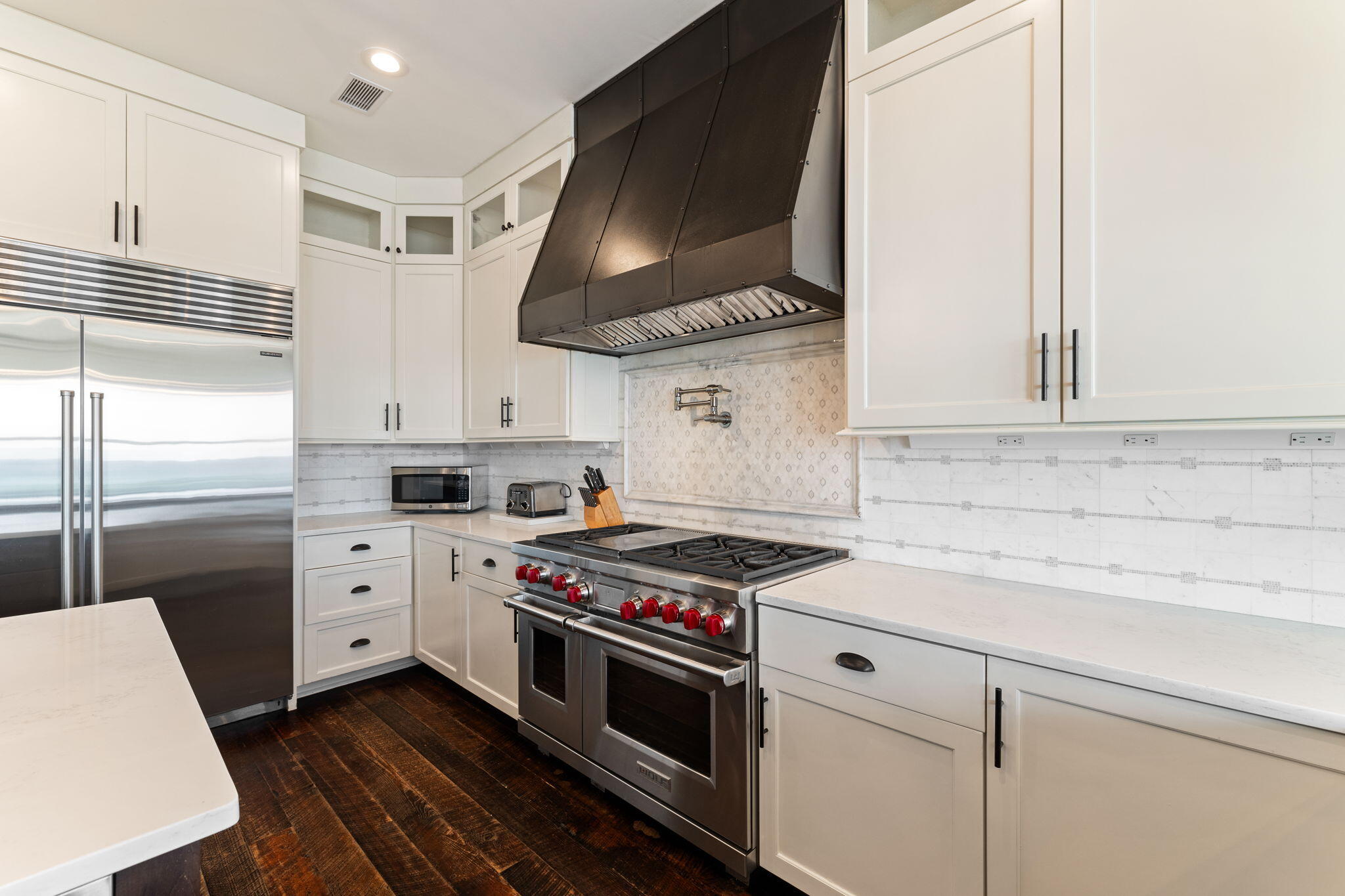 138 West Beach Drive Miramar Beach, FL 32550 - Photo 16 of 72 a kitchen with white cabinets and white appliances