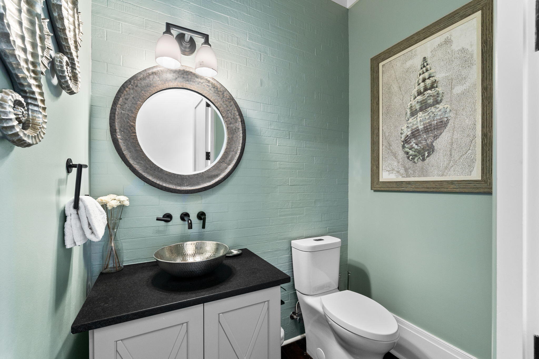 138 West Beach Drive Miramar Beach, FL 32550 - Photo 22 of 72 a bathroom with a toilet a sink and a mirror