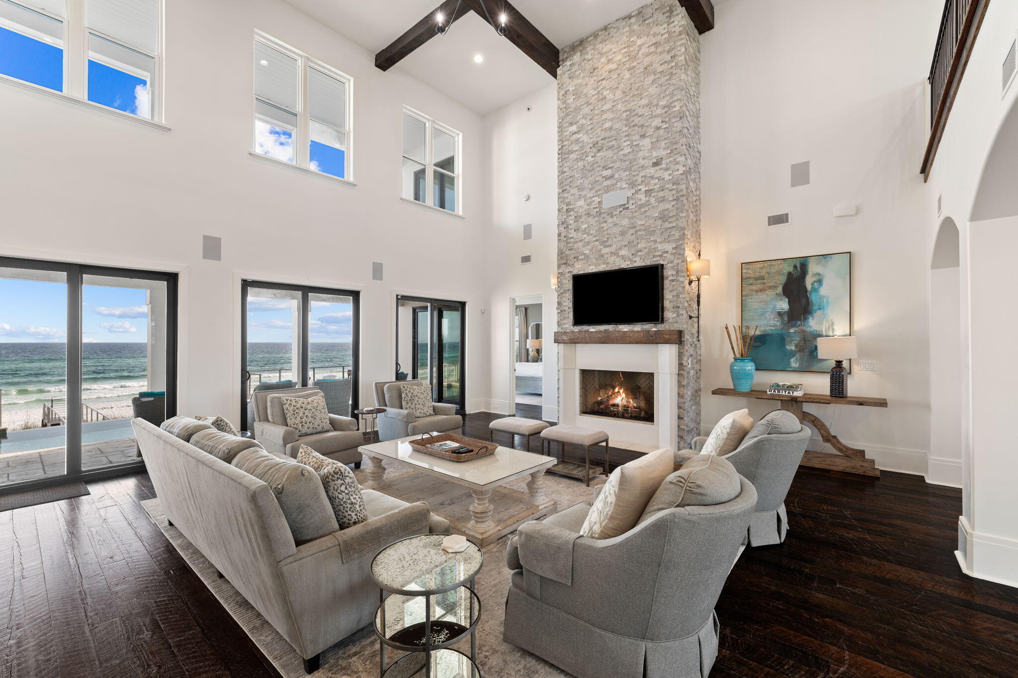138 West Beach Drive Miramar Beach, FL 32550 - Photo 7 of 72 a living room with furniture a fireplace and a floor to ceiling window