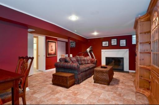 9 West Touhy Avenue Park Ridge, IL 60068 - Photo 5 of 8 a living room with furniture a fireplace and a large window