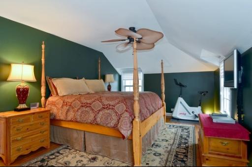 9 West Touhy Avenue Park Ridge, IL 60068 - Photo 7 of 8 a bedroom with a bed a dresser and potted plants