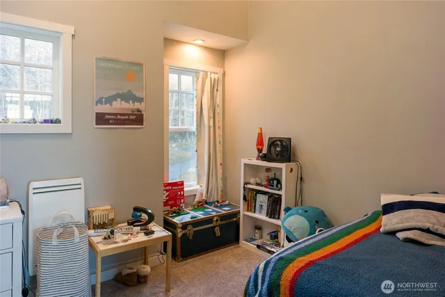 a bedroom with furniture and a window