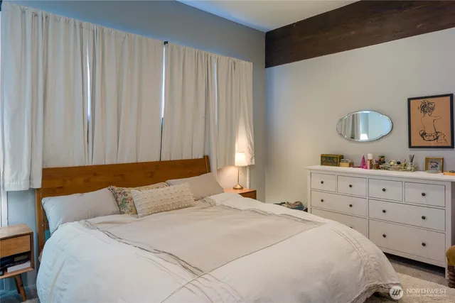 a bedroom with a bed and a dresser in it