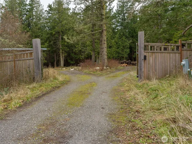 a view of a backyard with fence