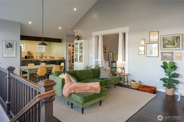 a living room with furniture kitchen view and a potted plant