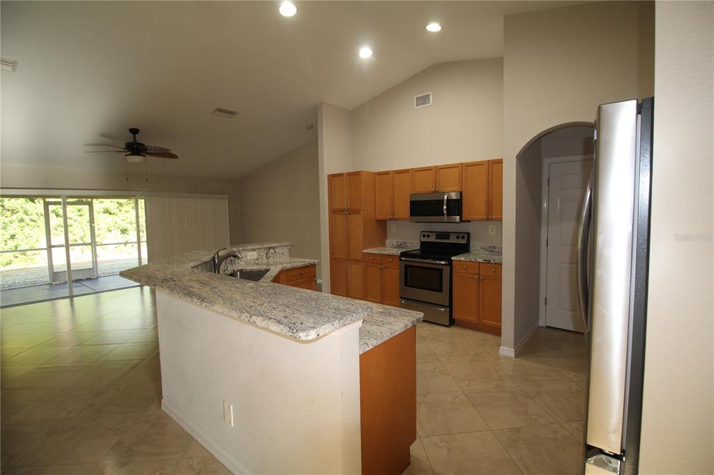 5508 Douglas Road North Port, FL 34288 - Photo 4 of 12 a kitchen with granite countertop a refrigerator and a sink