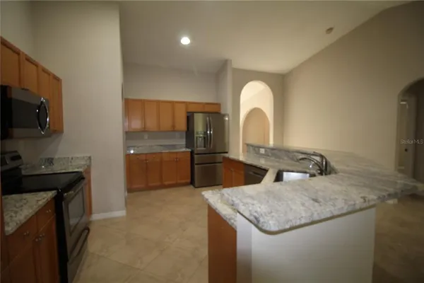 a kitchen with a sink and a refrigerator