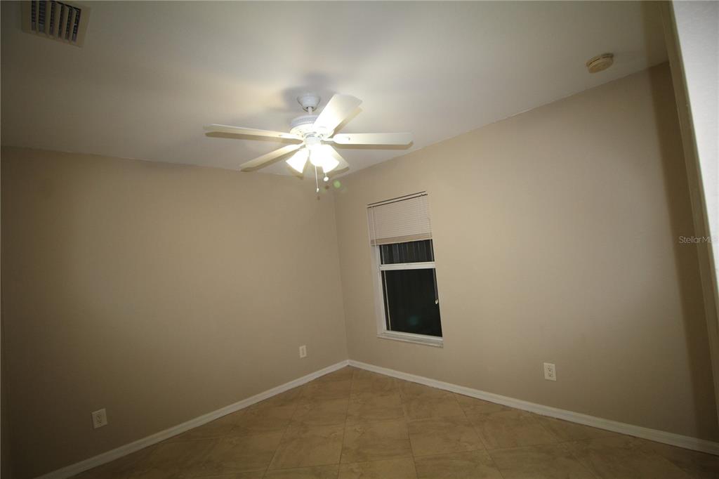 5508 Douglas Road North Port, FL 34288 - Photo 7 of 12 an empty room with a chandelier fan