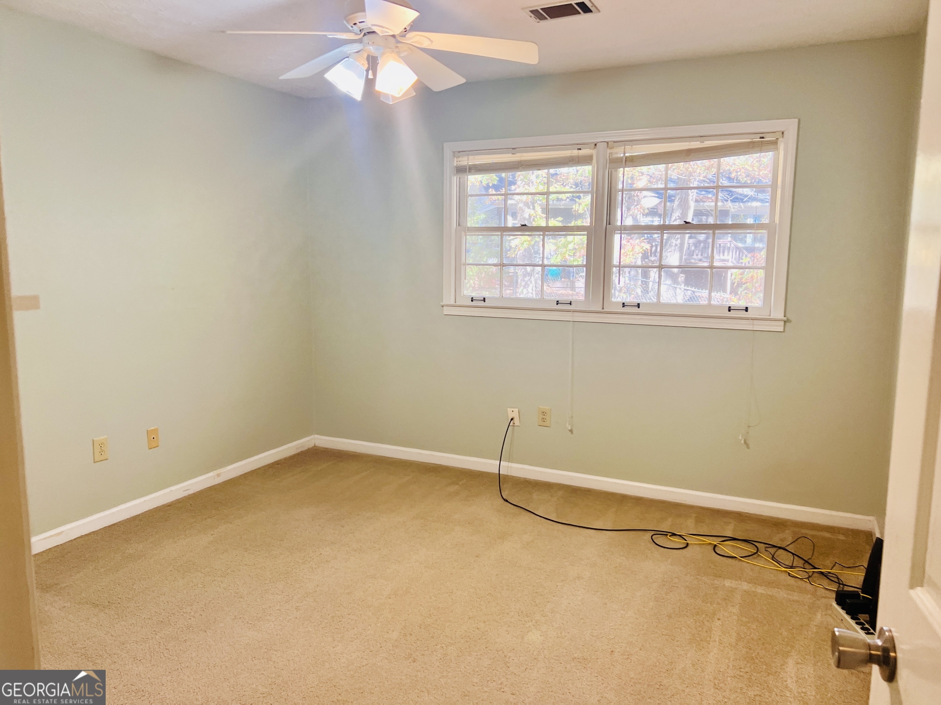 345 Caldwell Circle Athens, GA 30605 - Photo 15 of 38 an empty room with a window and a fan