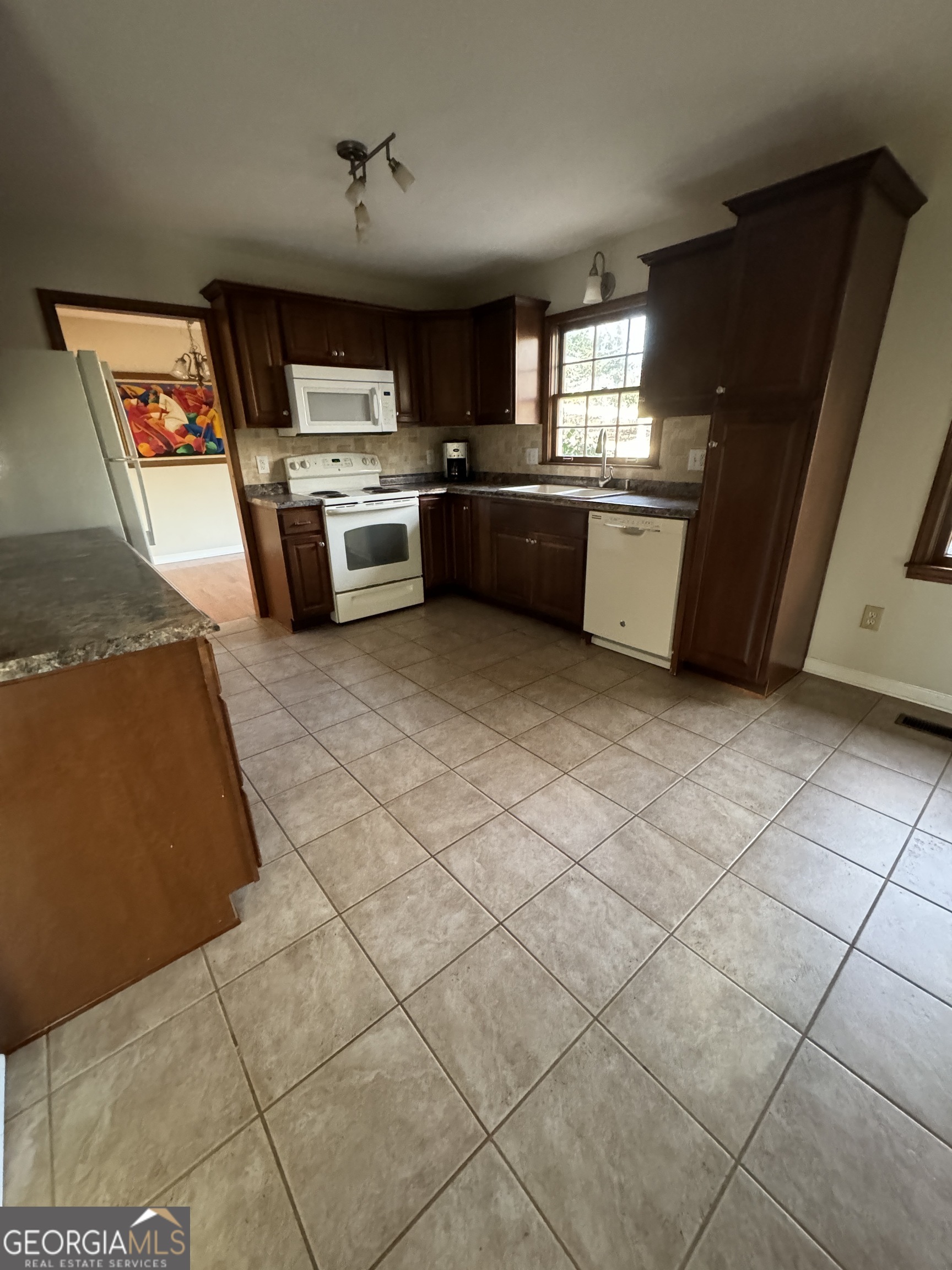 345 Caldwell Circle Athens, GA 30605 - Photo 21 of 38 a kitchen with stainless steel appliances granite countertop a sink and a stove