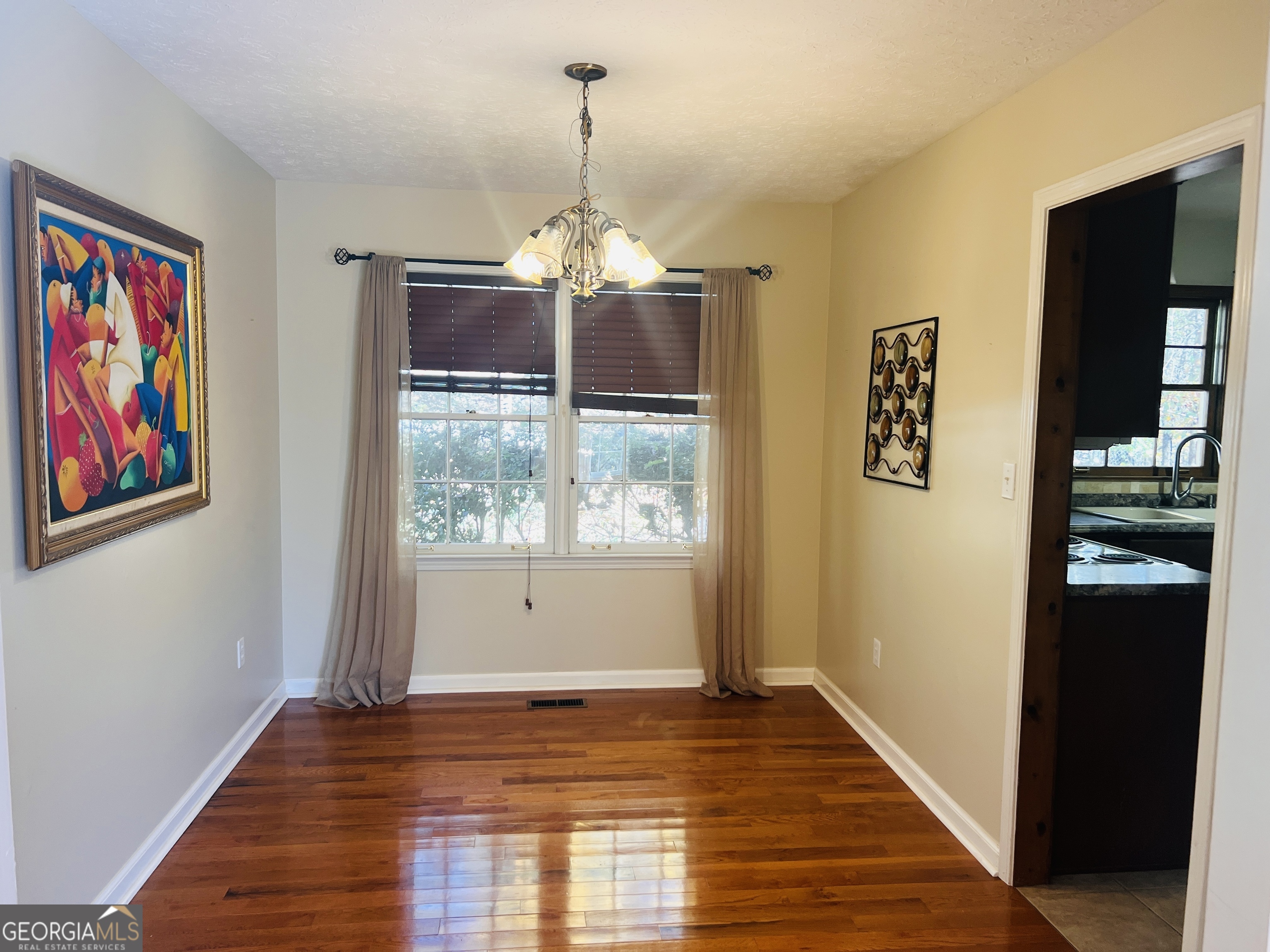 345 Caldwell Circle Athens, GA 30605 - Photo 5 of 38 a view of a bedroom with wooden floor chandelier and entryway