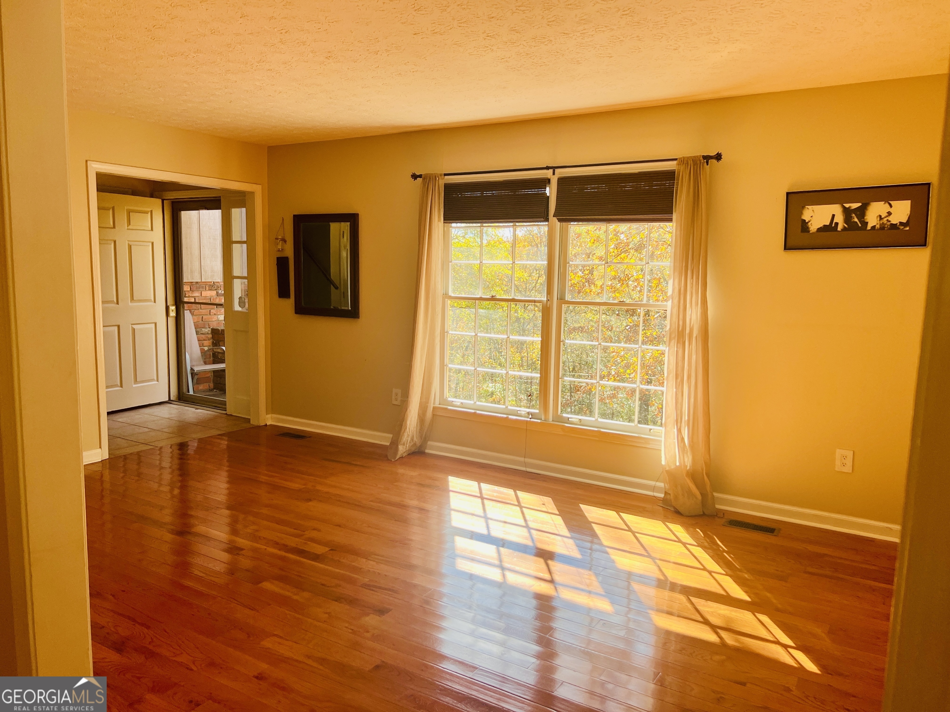 345 Caldwell Circle Athens, GA 30605 - Photo 6 of 38 a view of an empty room with window and wooden floor