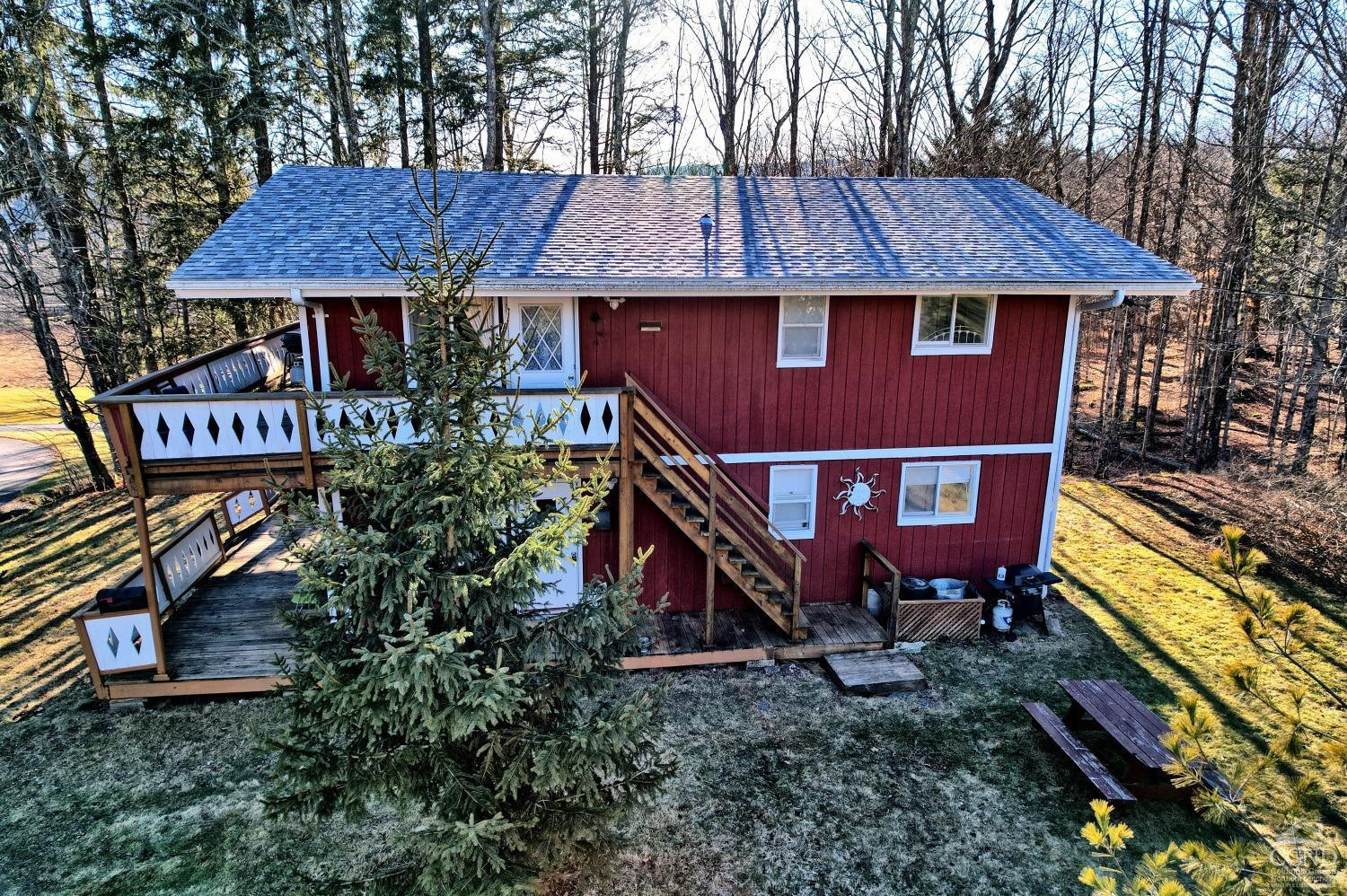 31 Showers Road Hunter, NY 12485 - Photo 76 of 89 a aerial view of a house with table and chairs under an umbrella