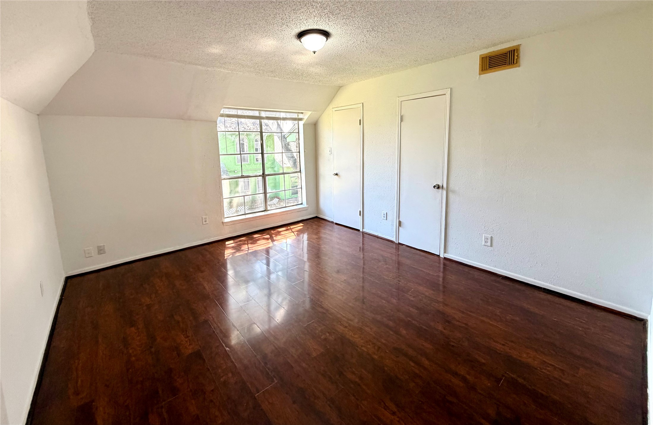7789 Cook Road Houston, TX 77072 - Photo 14 of 18 a view of an empty room with wooden floor and a window