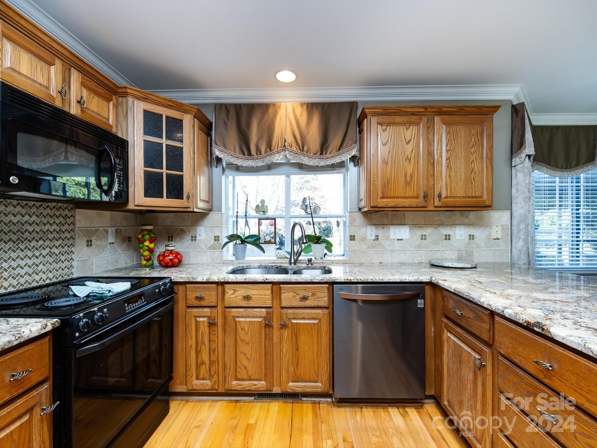 3534 Nestling Lane Fort Mill, SC 29708 - Photo 13 of 44 a kitchen with stainless steel appliances granite countertop a sink stove and cabinets