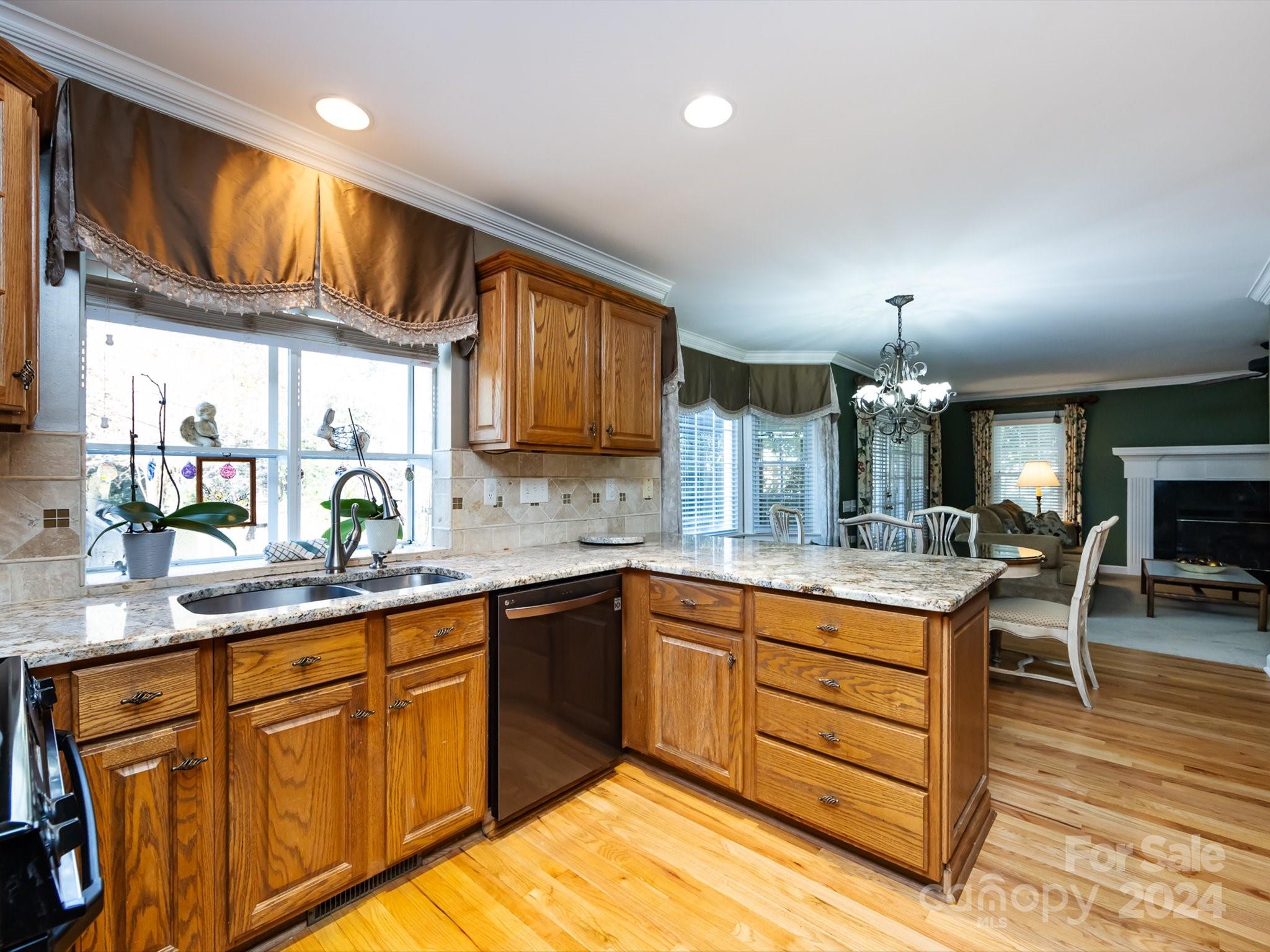 3534 Nestling Lane Fort Mill, SC 29708 - Photo 14 of 44 a kitchen with stainless steel appliances granite countertop sink stove refrigerator and cabinets