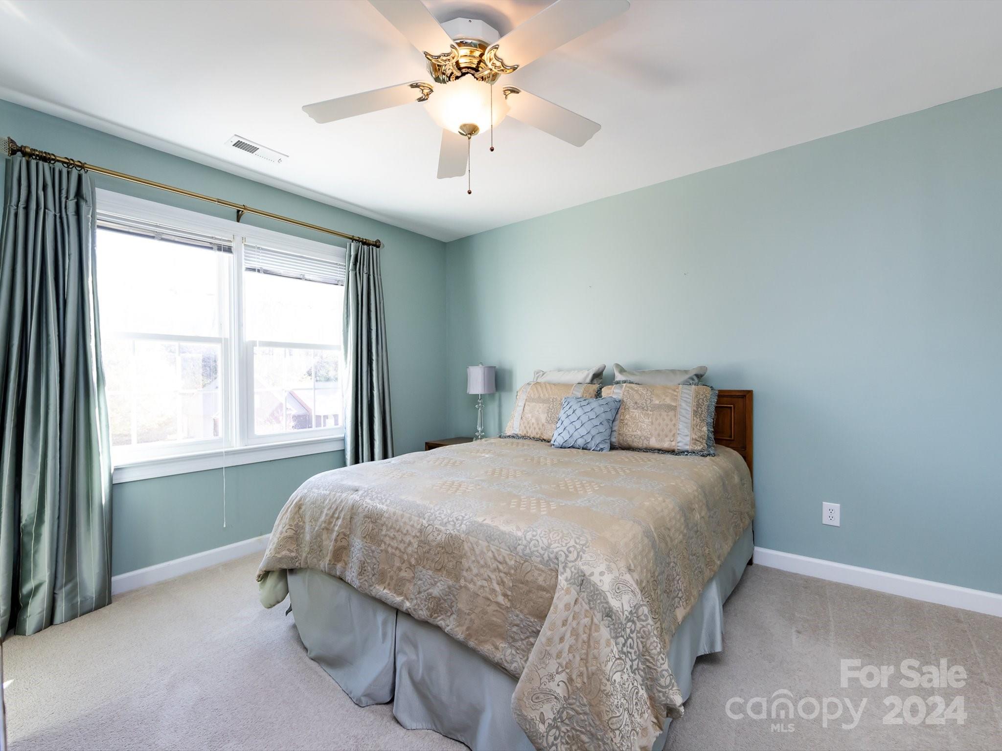 3534 Nestling Lane Fort Mill, SC 29708 - Photo 26 of 44 a bedroom with a large bed and a chandelier