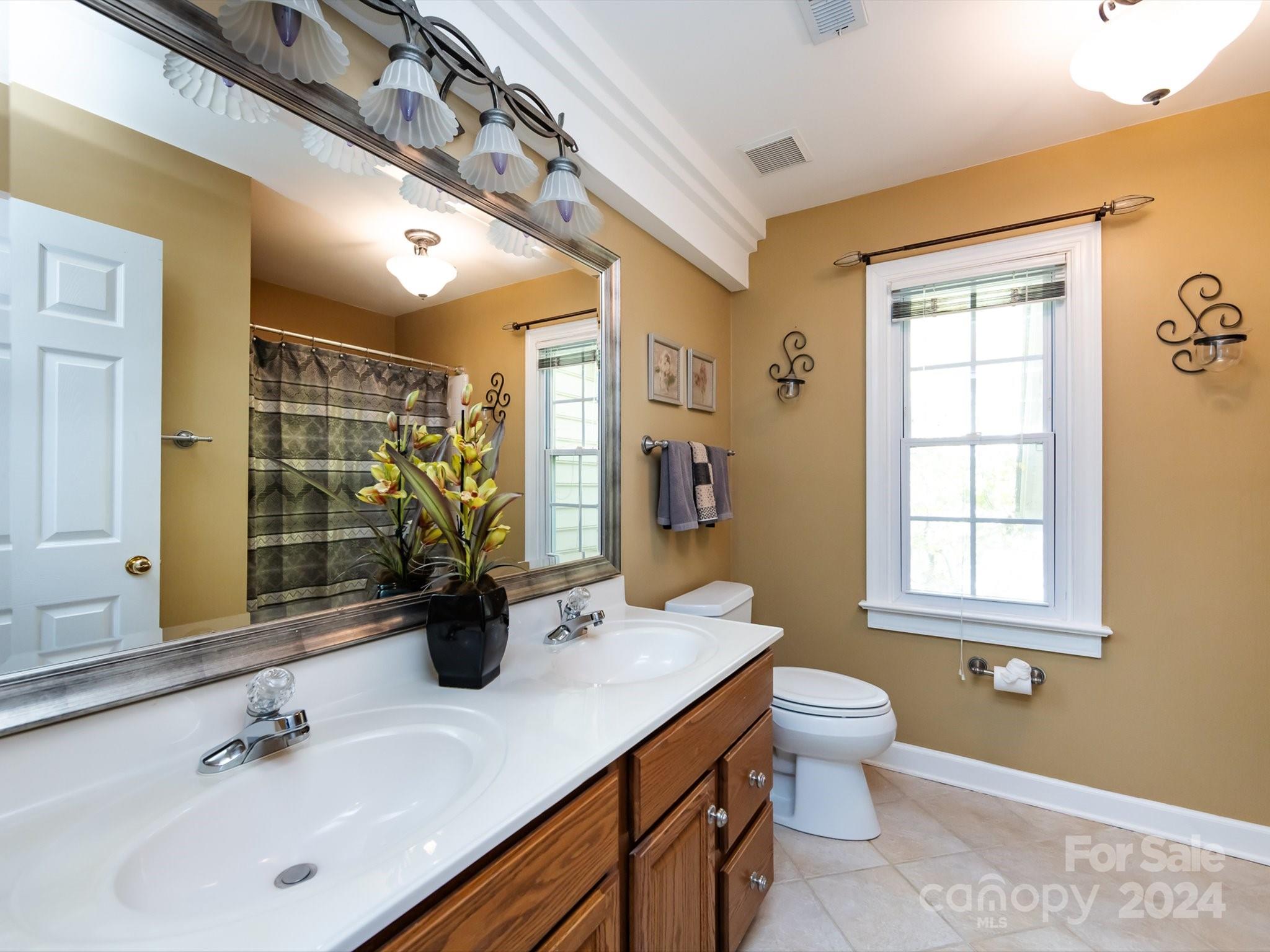 3534 Nestling Lane Fort Mill, SC 29708 - Photo 27 of 44 a bathroom with a double vanity sink toilet and a mirror