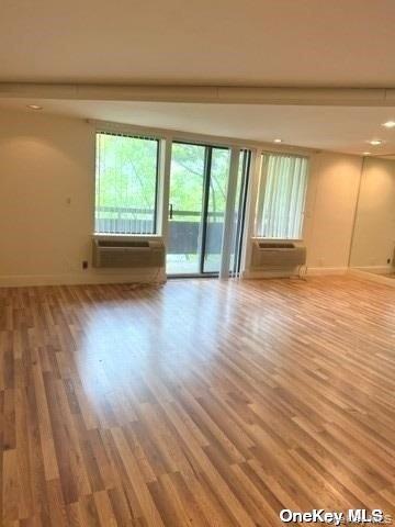 141 Great Neck Road, Unit 3A Great Neck, NY 11021 - Photo 4 of 15 a view of an empty room with wooden floor and a window