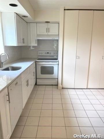 141 Great Neck Road, Unit 3A Great Neck, NY 11021 - Photo 6 of 15 a kitchen with a cabinets and white appliances