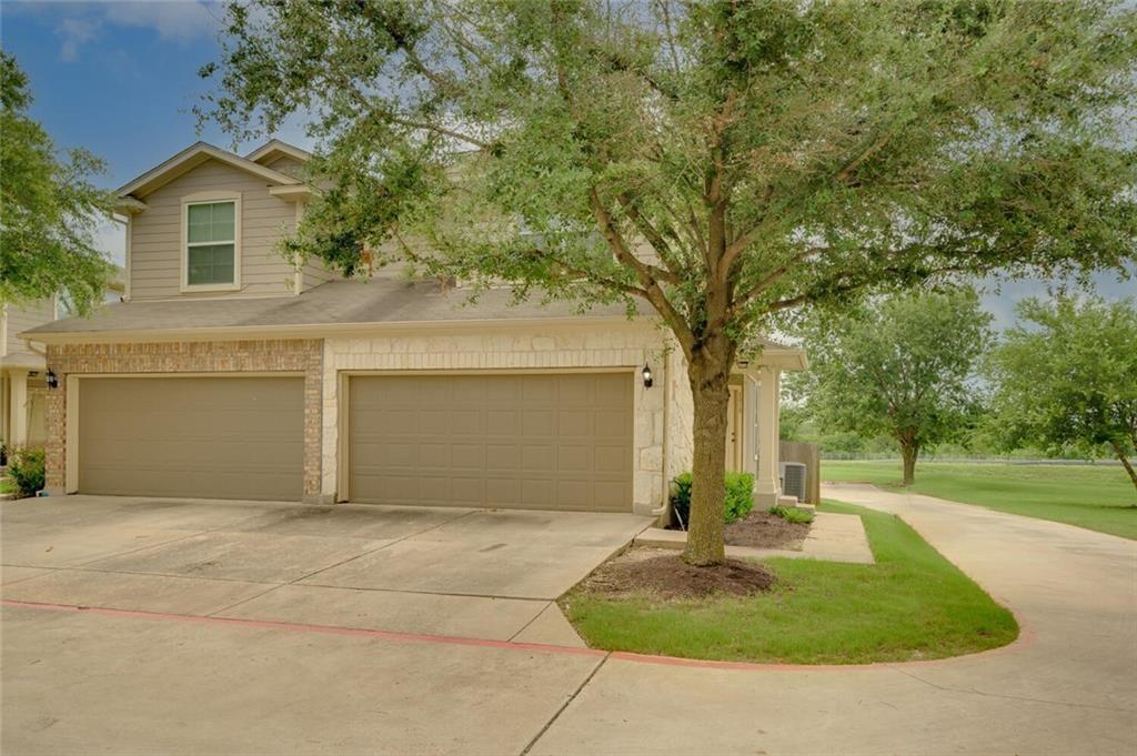 801 Jane Austen Trail, Unit B Pflugerville, TX 78660 - Photo 2 of 21 a front view of a house with garden